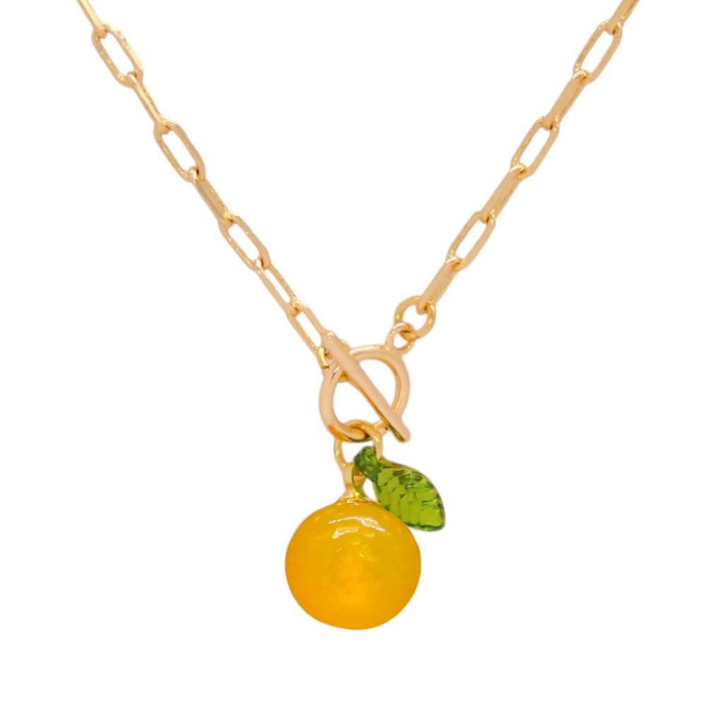 Gold necklace with a lemon-shaped pendant on a white background